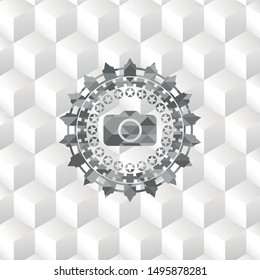photo camera icon inside grey badge with geometric cube white background