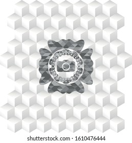 photo camera icon inside grey badge with geometric cube white background
