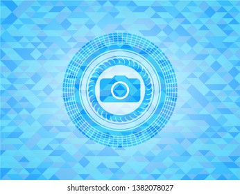 photo camera icon inside light blue emblem with mosaic background