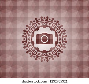 photo camera icon inside red seamless badge with geometric pattern background.