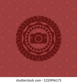 photo camera icon inside red emblem
