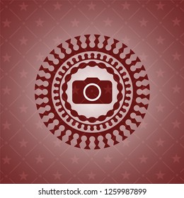photo camera icon inside red emblem