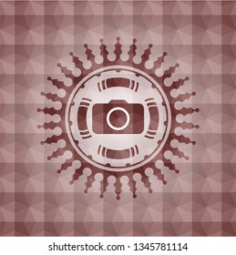 photo camera icon inside red seamless emblem or badge with abstract geometric polygonal pattern background.