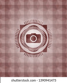 photo camera icon inside red seamless geometric emblem.