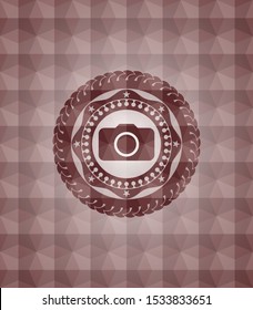 photo camera icon inside red emblem or badge with geometric pattern background. Seamless.
