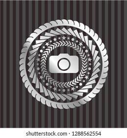 photo camera icon inside silvery emblem