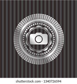 photo camera icon inside silvery emblem