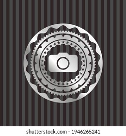photo camera icon inside silvery badge. 