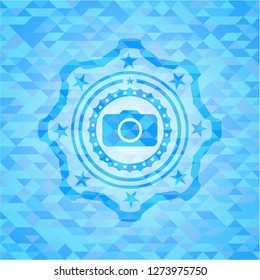 photo camera icon inside sky blue emblem. Mosaic background