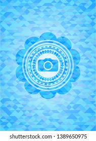 photo camera icon inside sky blue mosaic emblem