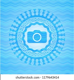 photo camera icon inside water representation badge.