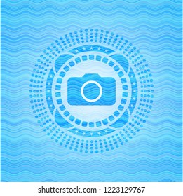 photo camera icon inside water representation style badge.