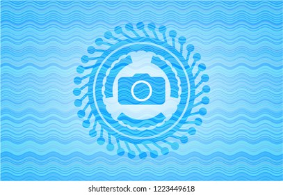 photo camera icon inside water emblem background.