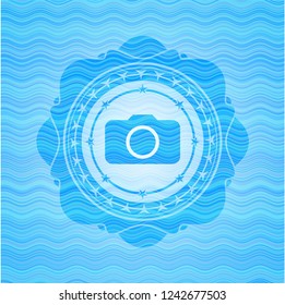 photo camera icon inside water wave concept emblem background.