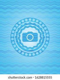photo camera icon inside water style badge.