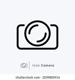 Photo camera icon in simple vector shape on bluish white background.