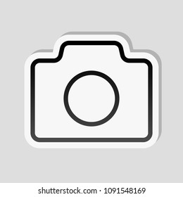 Photo camera, linear symbol with thin outline, simple icon. Sticker style with white border and simple shadow on gray background