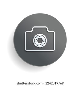 Photo camera, linear symbol with thin outline, simple icon. White paper symbol on gray round button or badge with shadow