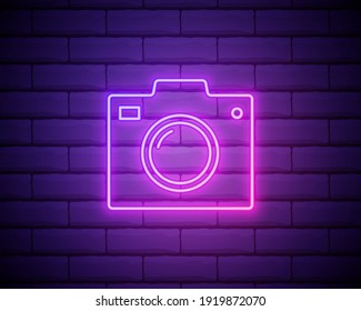 Photo camera pink neon icon. Sign photo Studio concept label or interface label for games, websites and mobile apps. Retro device in luminous linear style. Vector isolated on brick wall.