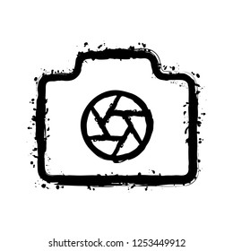 Photo camera with shutter, linear symbol with thin outline, simple icon. Black ink with splashes on white background