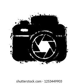 Photo camera with shutter, simple icon. Black ink with splashes on white background