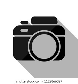 Photo camera, simple icon. Black object with long shadow on white background