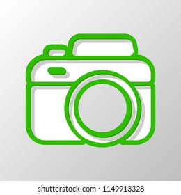 Photo camera, simple icon. Paper style. Cut symbol with green bold contour on shape and simple shadow