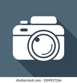 Photo camera, simple icon. White flat icon with long shadow on background