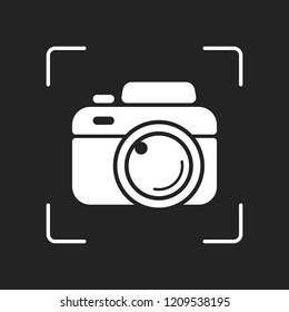 Photo camera, simple icon. White object in camera autofocus on dark background