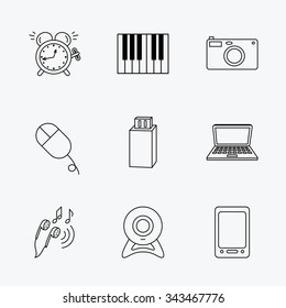 Photo camera, USB flash and notebook laptop icons. PC mouse, alarm clock and web camera linear signs. Tablet PC and music headphones icons. Linear black icons on white background.