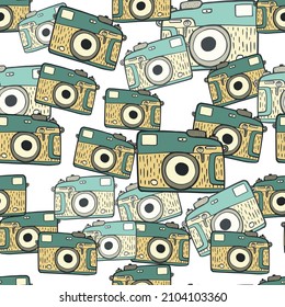 Photo camera vintage seamless pattern. Retro photo cameras design. Repeated texture in doodle style for fabric, wrapping paper, wallpaper, tissue. Vector illustration.