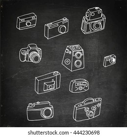 Photo cameras set. Hand drawn vector stock illustration. Chalk board drawing.