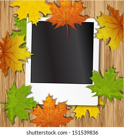  Photo frame with autumn leaves on wood background