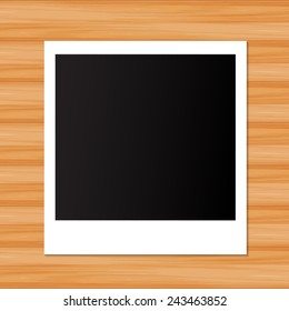 Photo frame on wooden background 