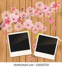 photo frame on wooden texture with cherry flowers