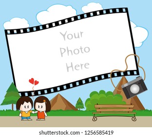 Photo frame with pretty scene behind two lovers plus a camera