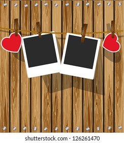 Photo frames on wood background. Valentine day card.