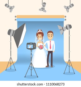 At photo studio with equipment and lightning. Marriage photoshoot.