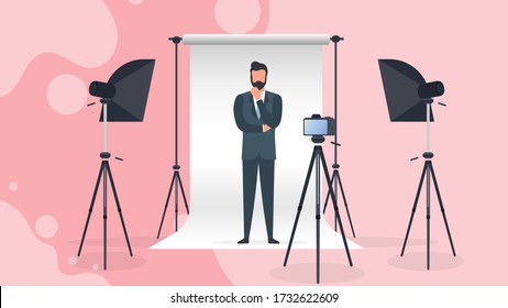 Photo Studio Vector. A man in a business suit poses for the camera. White canvas background on tripods. Camera on a tripod, softbox. Professional photo studio.