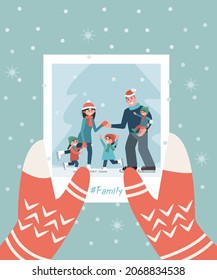 A photograph with a family in hand. Winter Christmas concept. Family photo on a background of snowflakes. Vector illustration in a flat style.