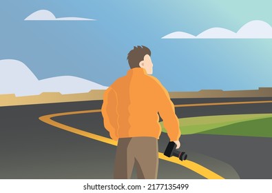 Photographer with camera in hands, orange jacket, brown pants, brown hair. White man. In the background is a road with a yellow stripe, sand mountains and clouds. A photographer's journey.