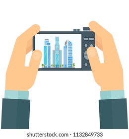 Photographer with a camera in his hands. Snapshot of cityscape. Flat cartoon illustration. Objects isolated on white background.