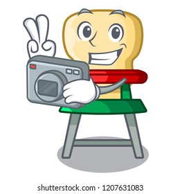 Photographer cartoon baby sitting in the highchair