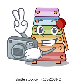 Photographer colorful toy xylophone on mallets mascot
