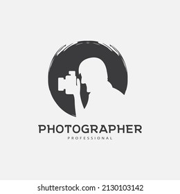 Photographer logo design silhouette holding a lens