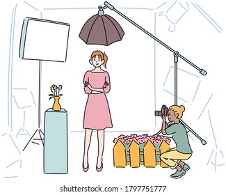 A photographer is shooting a model in a photo studio. hand drawn style vector design illustrations. 