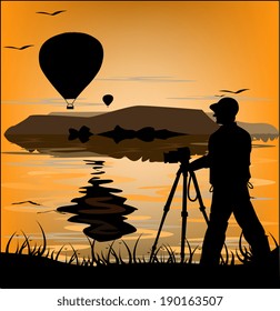 Photographer silhouette at sunset and flying balloons