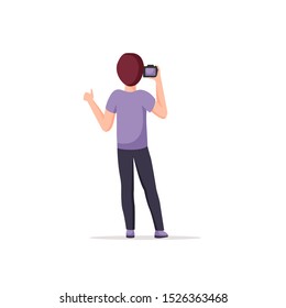 Photographer stands with his back, holding photo camera, demonstrating thumbs up hand gesture.  Young man take a photo shot, photographing. Isolated male cartoon character . Vector illustration