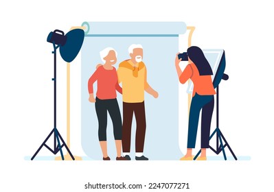 Photographer takes picture of old people. Senior family posing for portrait. Photo studio with professional lighting. Cameraman making snapshots. Photography shooting