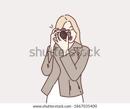 Photographer woman girl is holding dslr camera taking photographs. Hand drawn style vector design illustrations.